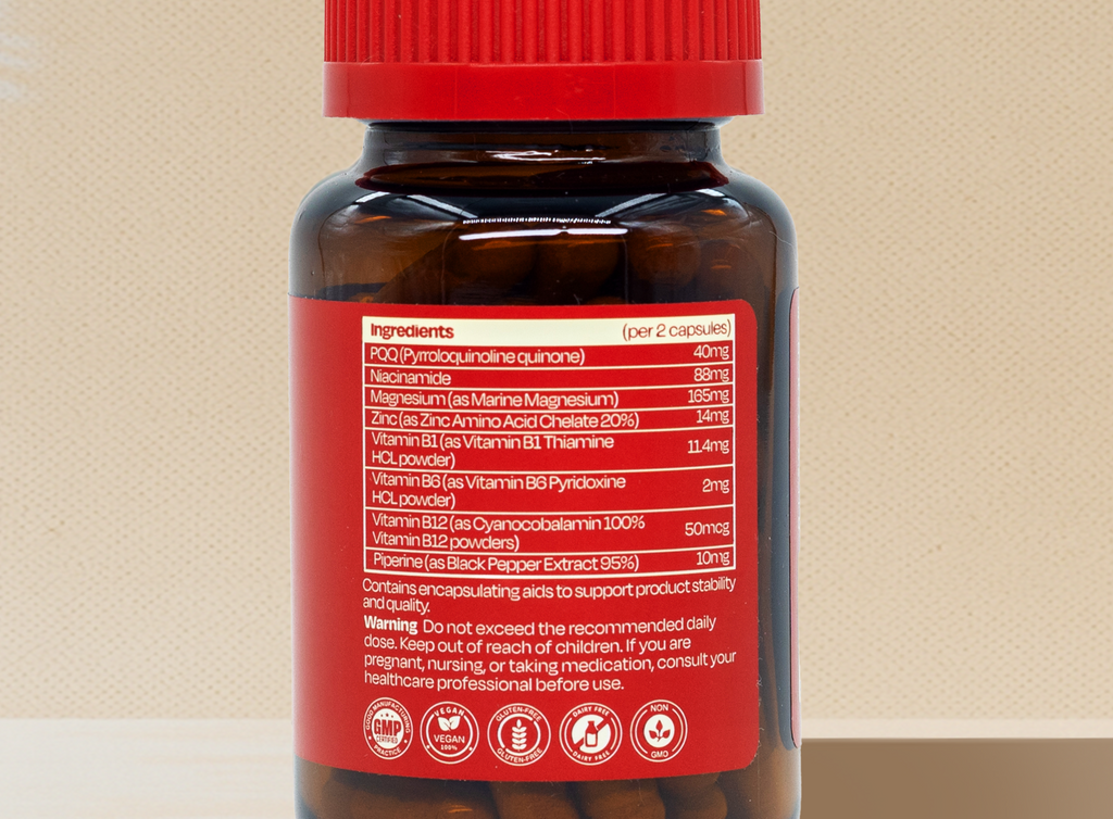 Reset capsule bottle with red cap on a beige background