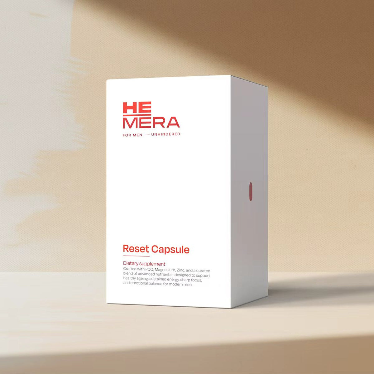 HEMĒRA Reset Capsule box, angled view, on a beige surface in soft sunlight